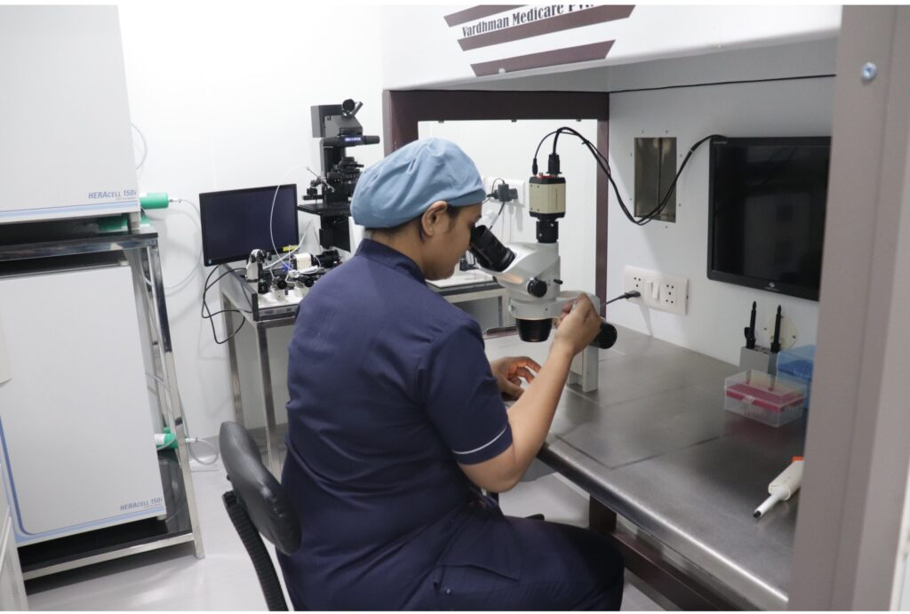 🧪 ivf lab in ahmedabad – ayuh fertility center 1 Lab technician performing microscopic procedure in ivf lab with advanced equipment
