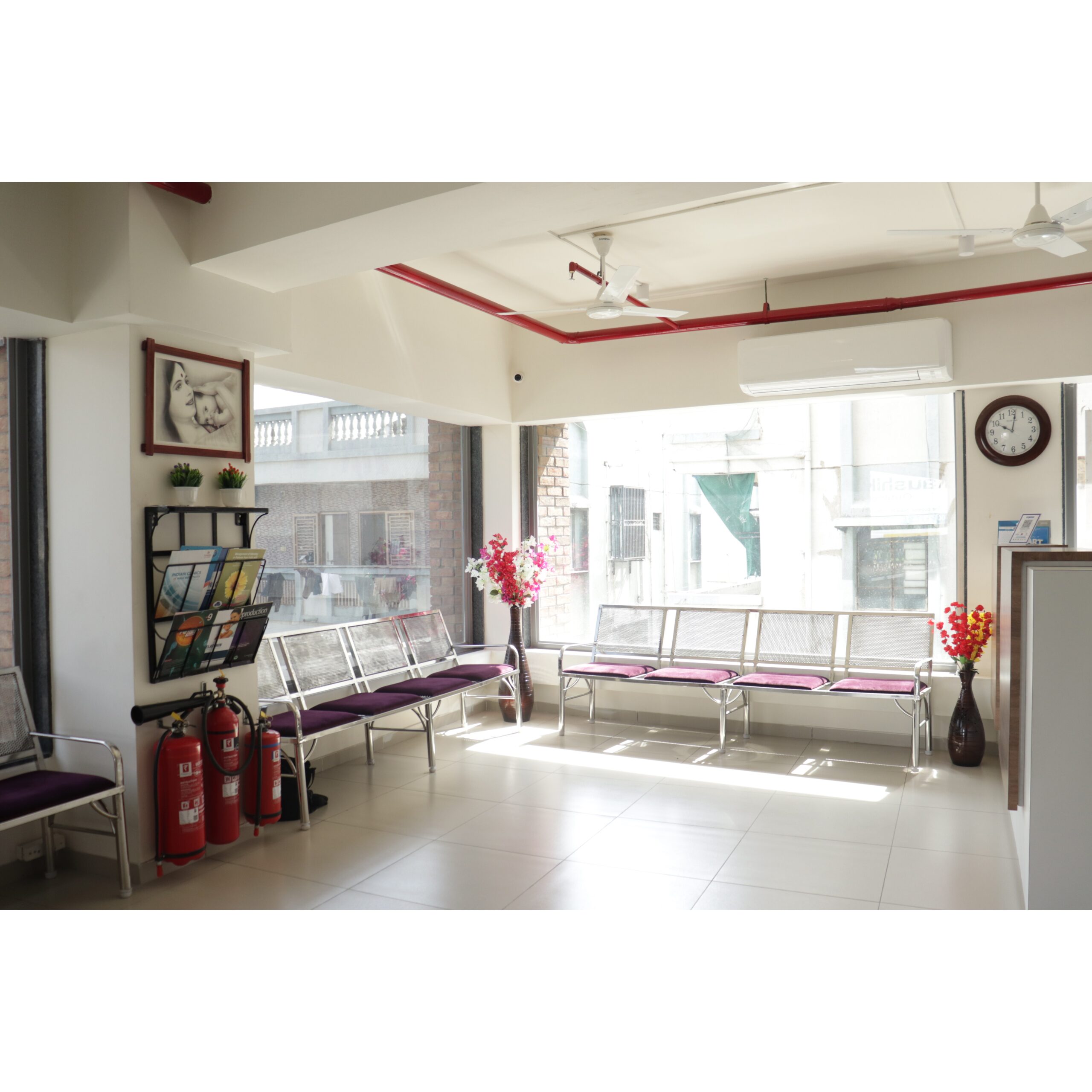 Best ivf center in ahmedabad - ayuh fertility 2 Clean and bright hospital waiting area with chairs, natural light, and patient information stand